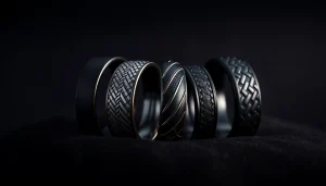 Showcase black wedding rings for men with unique designs and textures against a dark backdrop.